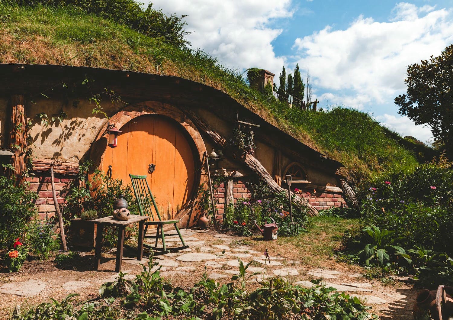 brown and orange house with outdoor plants