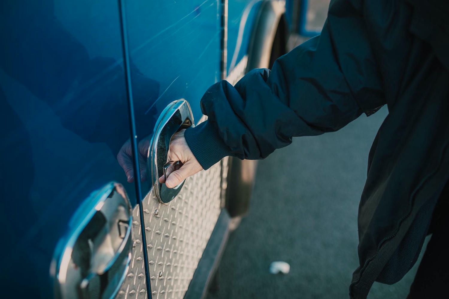 person holding on ambulance door handle
