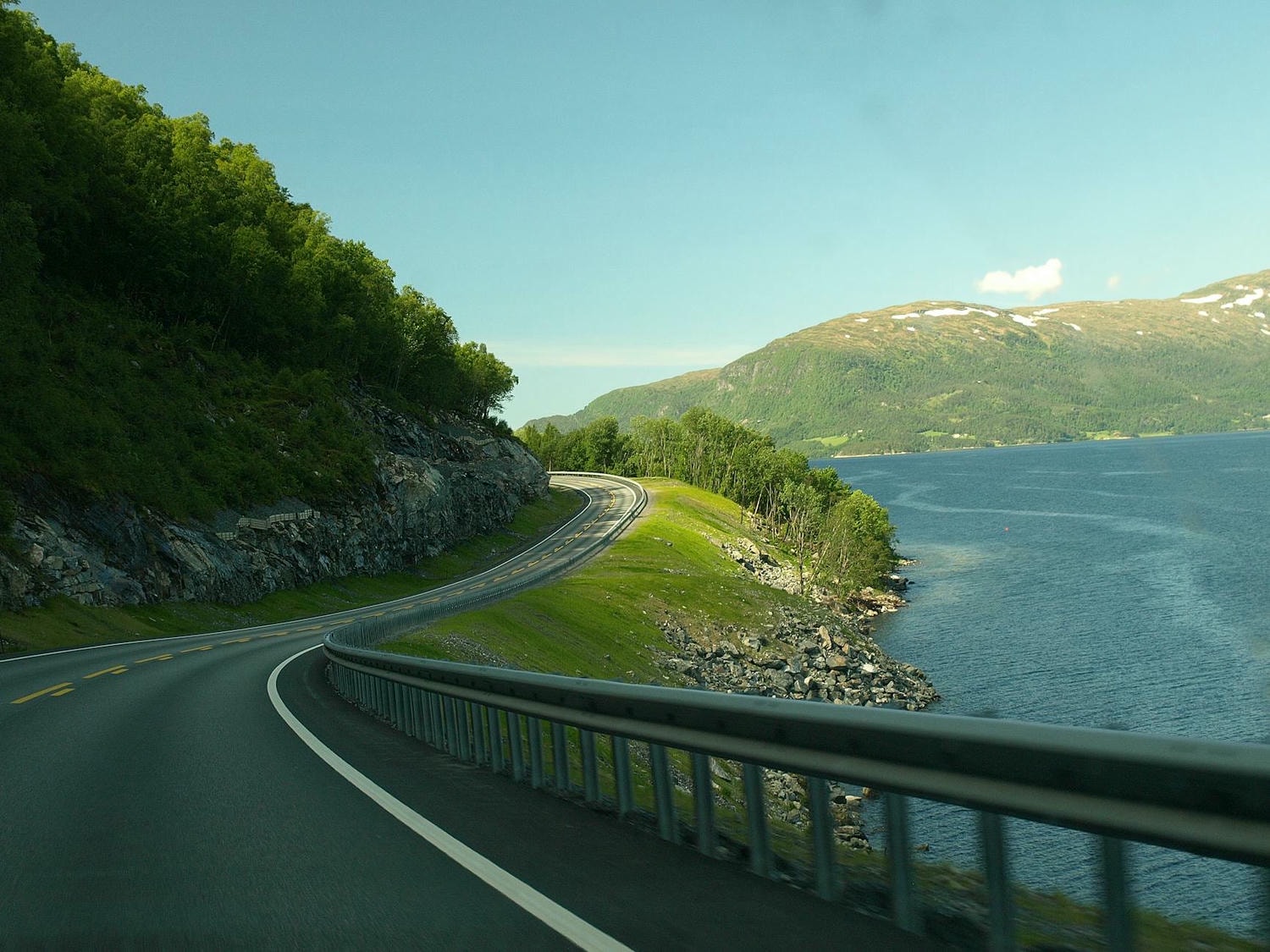 concrete road near body of water