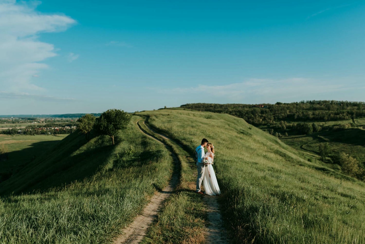 man and woman standing near green grass