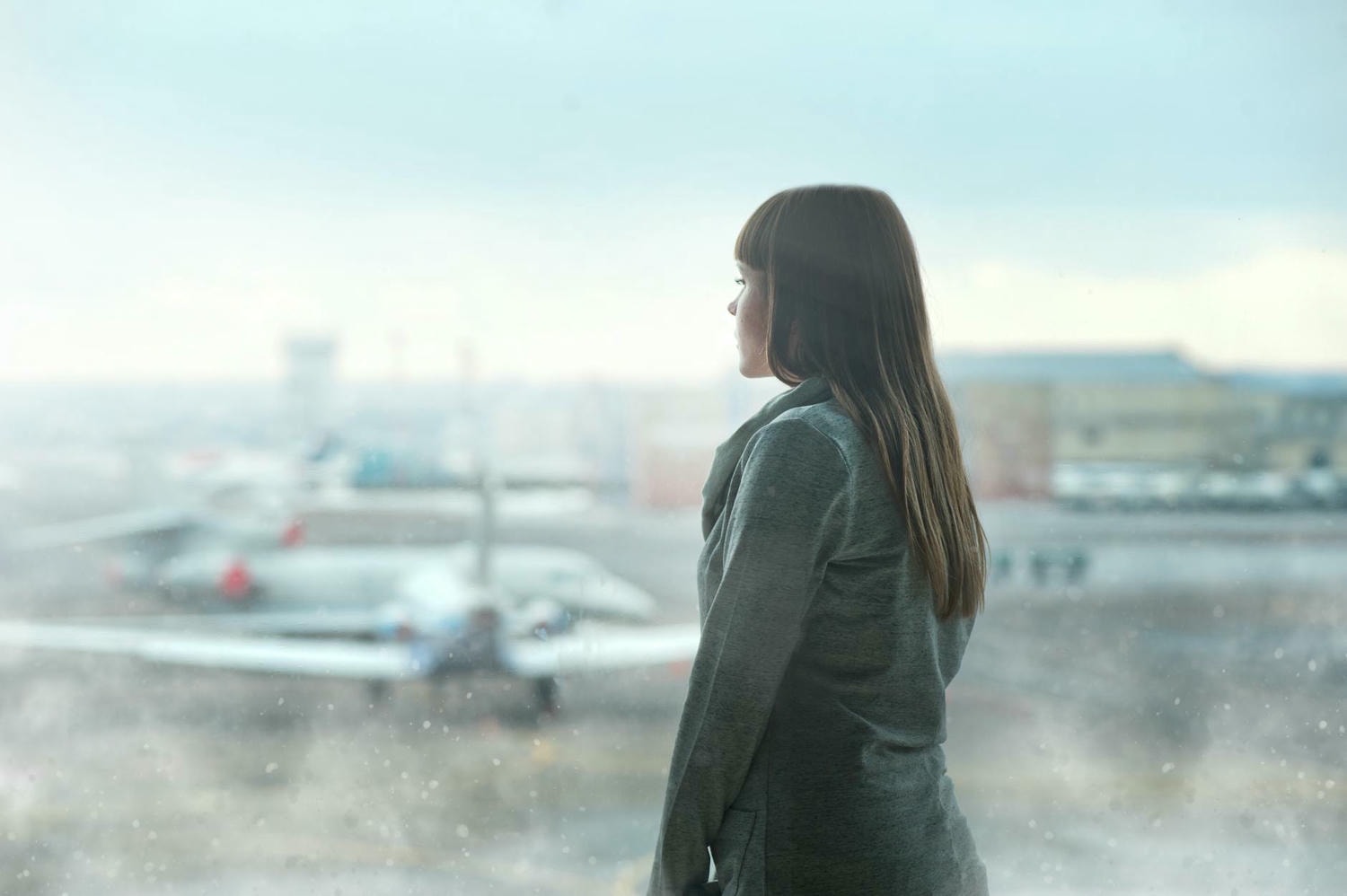 woman looking through the glass wall