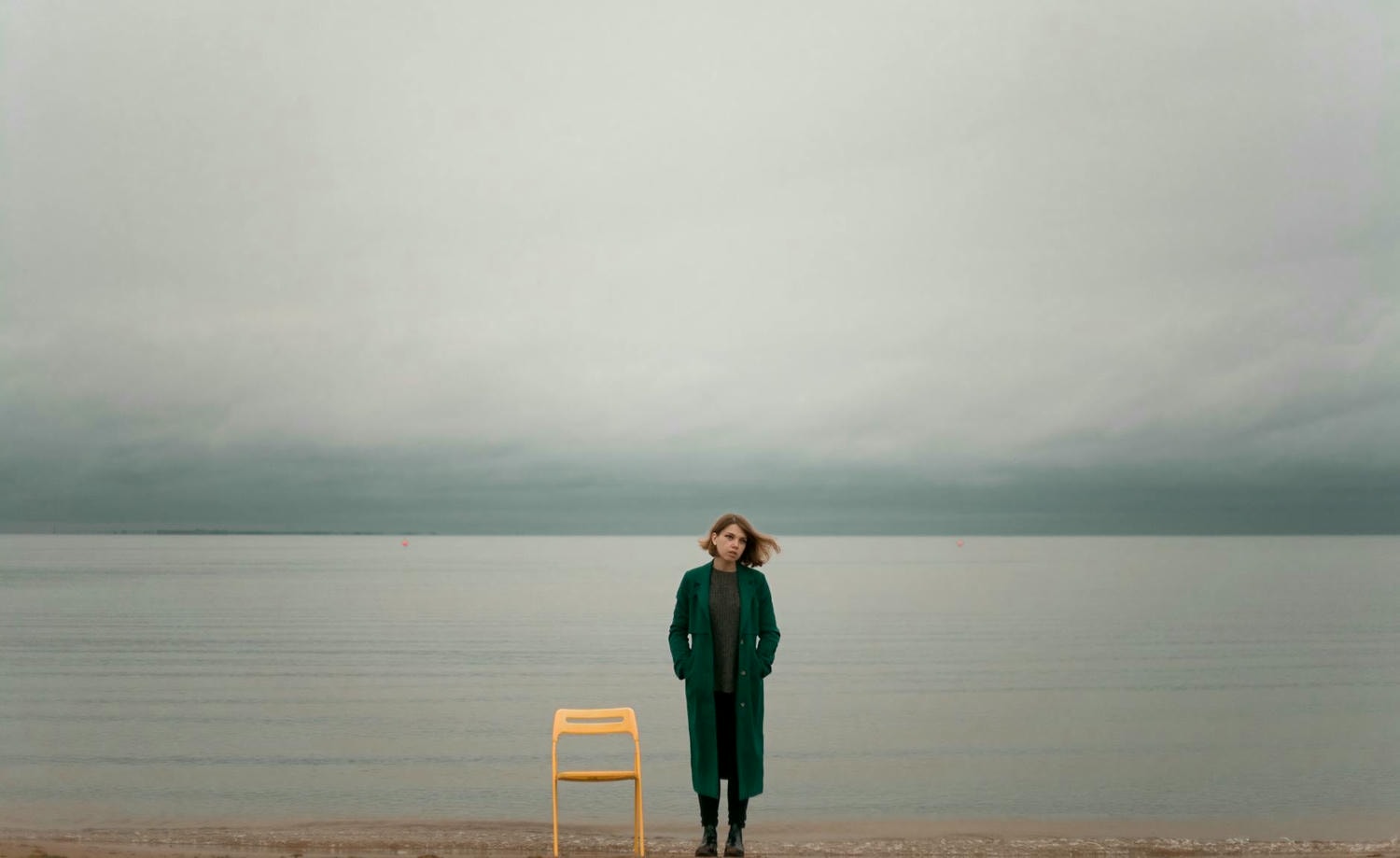 woman standing beside chair