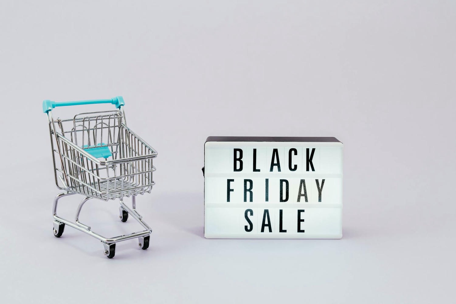 shopping cart next to a black friday sale sign